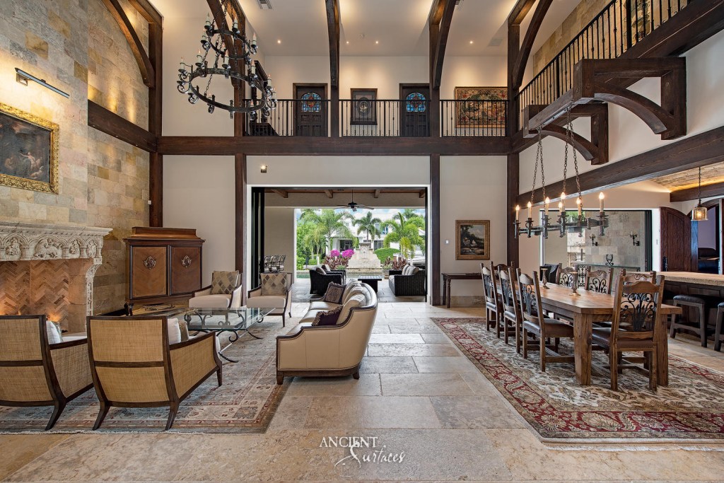 Spacious limestone living room seamlessly transitioning into an outdoor area, showcasing the versatility and timeless appeal of Ancient Surfaces' architectural design. 
Antique Millennium Planks from Malta
Reclaimed Limestone Mantle
