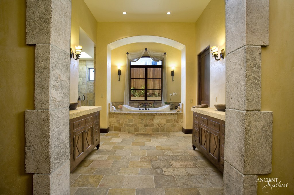 Exquisite limestone bathroom featuring a handcrafted stone bathtub and sink, showcasing the timeless elegance and craftsmanship of Ancient Surfaces.
Arcane Stone Flooring
Antique Foundation Slabs