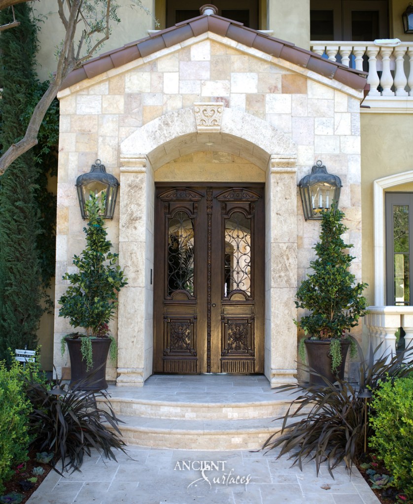 Grand entrance of a home featuring a beautifully crafted limestone archway and steps by Ancient Surfaces.
Arcane Stone Wall Cladding