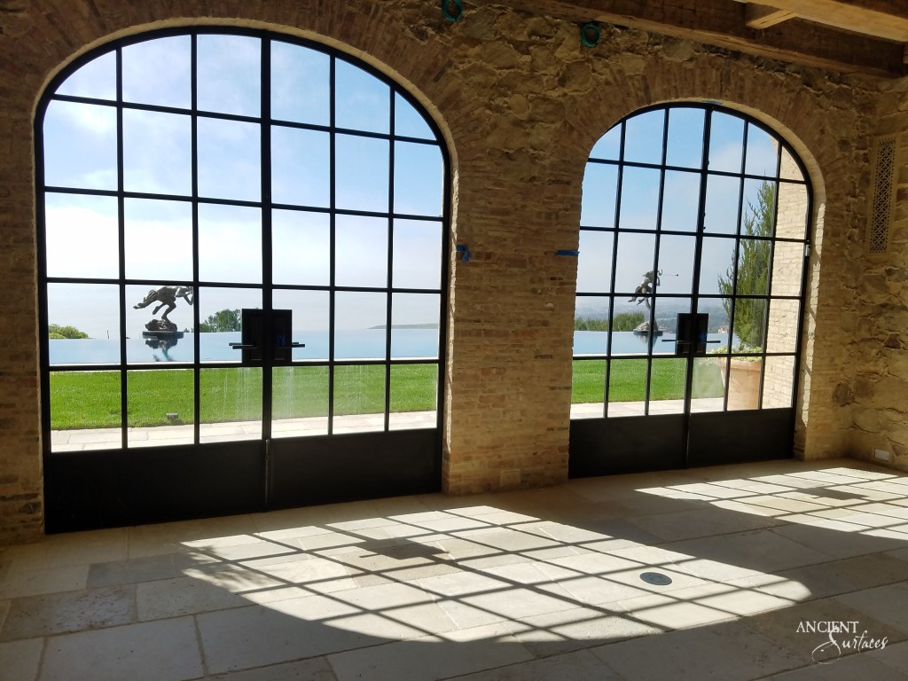 Close-up of the villa's limestone flooring, reflecting the hues of Mediterranean afternoons and capturing the play of light and shadow.