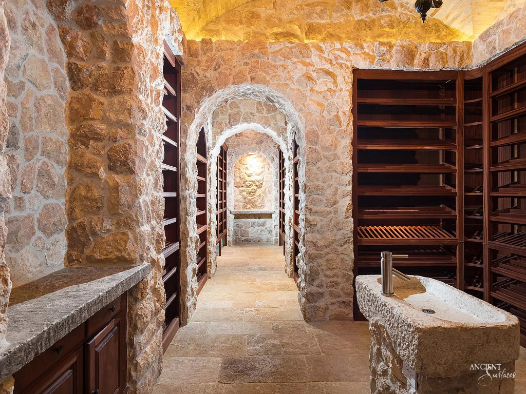 rustic wine cellar by Ancient Surfaces, its antique limestone structure housing a vast collection of wines in a serene setting
Antique Limestone Cladding
Ancient Limestone Vault
Coffered Ceiling in Stone
Antique Tuscan Wall Cladding
Reclaimed Limestone Flooring
Antique Kronos Stone 
Wine Tasting Room 
Antique Limestone Trough
Old Limestone Sink 
Circular Ceiling 
Antique Butcher Blocks
Antique Limestone Slabs
Antique Foundation Blocks
